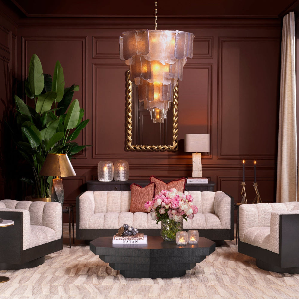 Luxurious living room with white sofa, armchairs, and decorative elements.