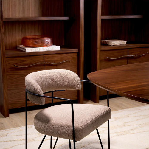 Two modern chairs in a room with wooden furniture and decor.