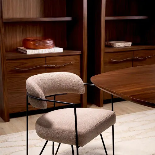 Two modern chairs in a room with wooden furniture and decor.