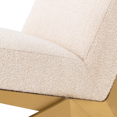 Close-up of a textured beige chair with a gold metal base.