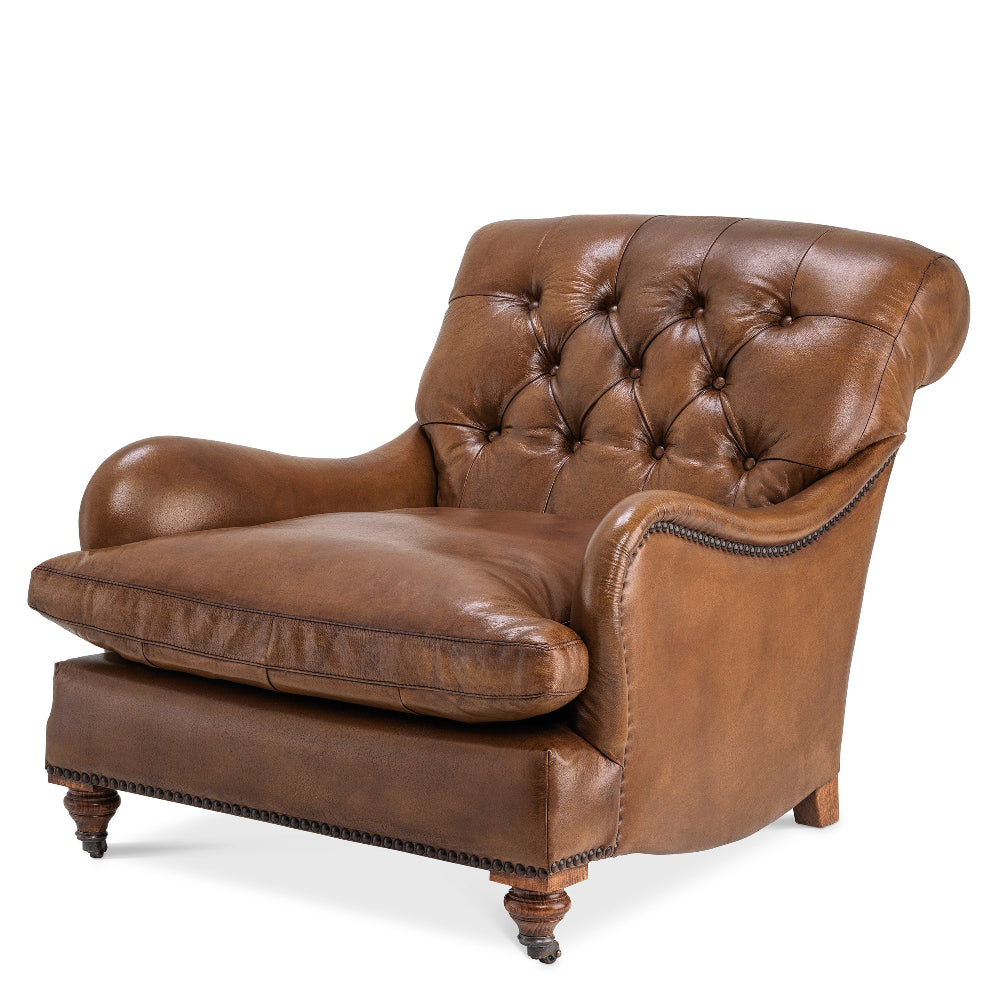 A brown leather tufted backrest club chair with wooden legs.