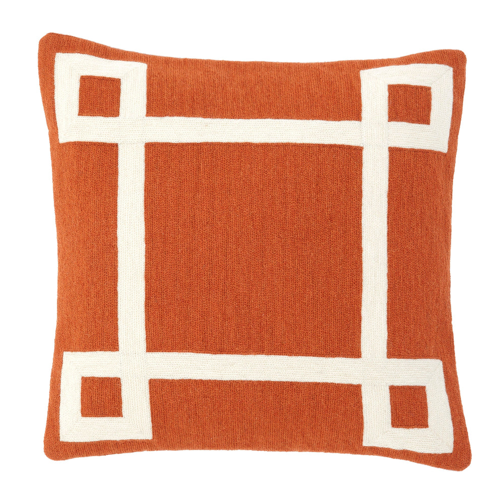A square-shaped orange and white hand embroidered cushion with a geometric pattern.