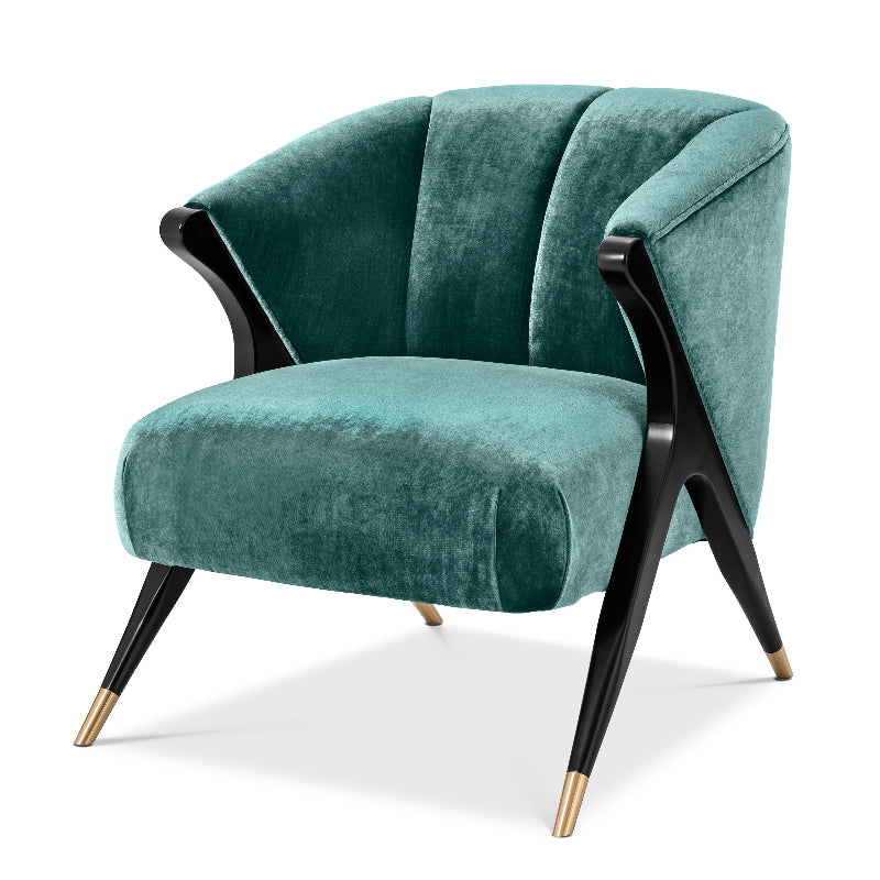 A green upholstered Pavone chair with black frame and gold accents on the legs.