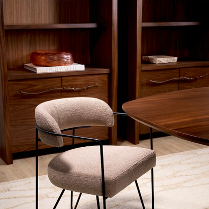 Two modern chairs in a room with wooden furniture and decor.