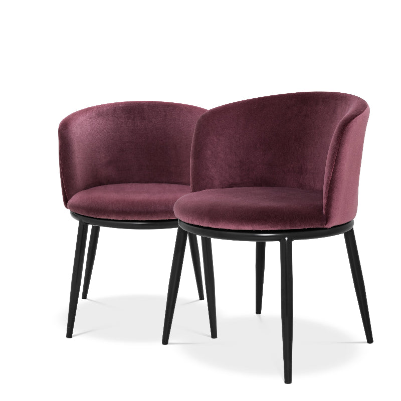 A pair of purple upholstered dining chairs with a modern design, featuring black legs and a high-gloss finish.